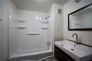 Step into this sun-filled 2 bedroom, 2 bath retreat where modern on Date Palm Country Club in California - for sale on GolfHomes.com, golf home, golf lot