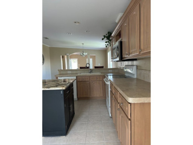 GORGEOUS OPEN AND SPLIT FLOOR PLAN HOME WITH TRAY CEILINGS AND on Silver Dollar Golf and Trap Club in Florida - for sale on GolfHomes.com, golf home, golf lot