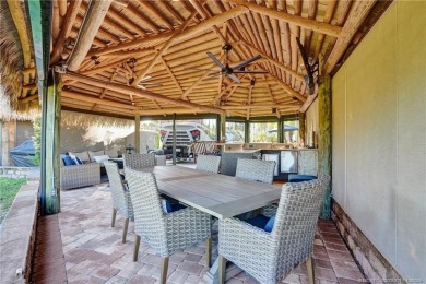 Turnkey RV Lot with Premium Tiki and Lake Views! Enjoy on Motorcoach Resort Golf Course in Florida - for sale on GolfHomes.com, golf home, golf lot