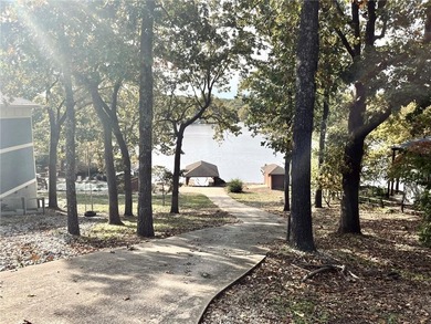 Experience resort-style living with this exceptional lakefront on Bella Vista Country Club - Berksdale in Arkansas - for sale on GolfHomes.com, golf home, golf lot