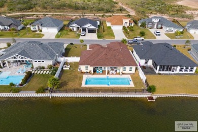 Discover this beautiful 3-bedroom, 2-bathroom lakeside home in on South Padre Island Golf Club in Texas - for sale on GolfHomes.com, golf home, golf lot