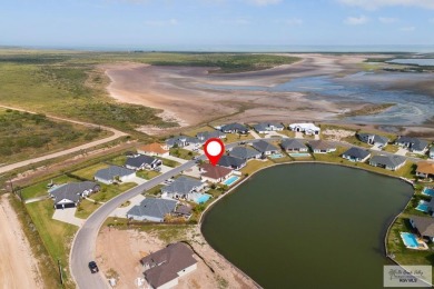 Discover this beautiful 3-bedroom, 2-bathroom lakeside home in on South Padre Island Golf Club in Texas - for sale on GolfHomes.com, golf home, golf lot