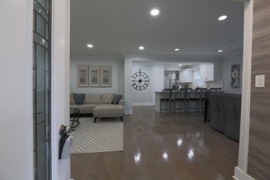 This cottage style bungalow surrounded by a white picket fence on Evergreen Hills Golf Course in Michigan - for sale on GolfHomes.com, golf home, golf lot