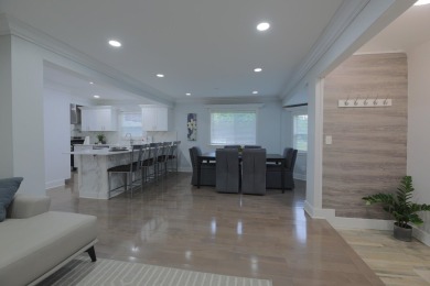 This cottage style bungalow surrounded by a white picket fence on Evergreen Hills Golf Course in Michigan - for sale on GolfHomes.com, golf home, golf lot