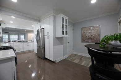 This cottage style bungalow surrounded by a white picket fence on Evergreen Hills Golf Course in Michigan - for sale on GolfHomes.com, golf home, golf lot
