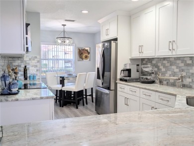 Enjoy this Beautiful two-story pool home, in the private and on The Grand Club - Pine Lakes Course in Florida - for sale on GolfHomes.com, golf home, golf lot
