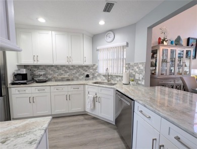 Enjoy this Beautiful two-story pool home, in the private and on The Grand Club - Pine Lakes Course in Florida - for sale on GolfHomes.com, golf home, golf lot