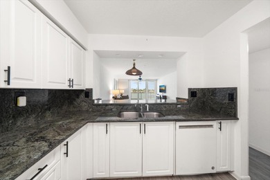 Under contract-accepting backup offers. WATERFRONT LIVING WITH on Isla Del Sol Yacht and Country Club in Florida - for sale on GolfHomes.com, golf home, golf lot