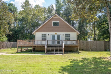 This beautifully updated and recently renovated 3-bedroom on Diamondhead Country Club in Mississippi - for sale on GolfHomes.com, golf home, golf lot