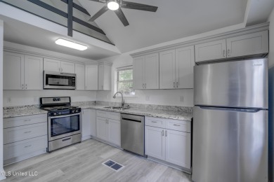 This beautifully updated and recently renovated 3-bedroom on Diamondhead Country Club in Mississippi - for sale on GolfHomes.com, golf home, golf lot