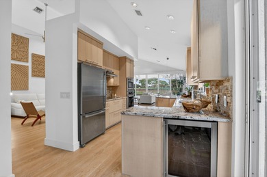 Discover refined single-story living in the prestigious Whisper on Broken Sound Golf and Club  in Florida - for sale on GolfHomes.com, golf home, golf lot