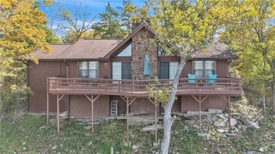 This home boasts a view like few others can perched high on a on Holiday Island Executive Golf Course in Arkansas - for sale on GolfHomes.com, golf home, golf lot