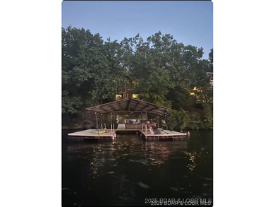 Discover lake living at its finest in the iconic Tan-Tar-A on The Oaks Golf Course in Missouri - for sale on GolfHomes.com, golf home, golf lot