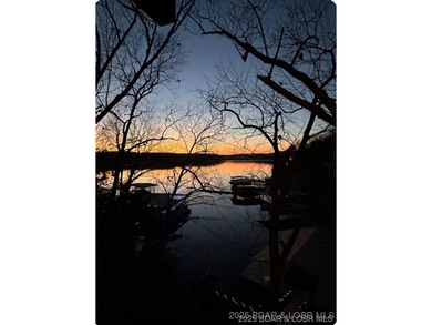 Discover lake living at its finest in the iconic Tan-Tar-A on The Oaks Golf Course in Missouri - for sale on GolfHomes.com, golf home, golf lot