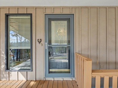 Want a comfortable cabin at the lake? This home offers wooded on The Greens at Deerfield in Tennessee - for sale on GolfHomes.com, golf home, golf lot