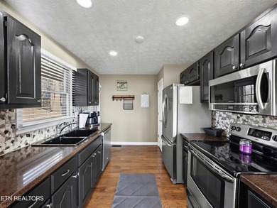 Want a comfortable cabin at the lake? This home offers wooded on The Greens at Deerfield in Tennessee - for sale on GolfHomes.com, golf home, golf lot