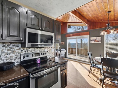 Want a comfortable cabin at the lake? This home offers wooded on The Greens at Deerfield in Tennessee - for sale on GolfHomes.com, golf home, golf lot