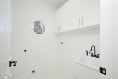 Set on an expansive golf course lot with mature, lush on Spruce Creek Golf Club in Florida - for sale on GolfHomes.com, golf home, golf lot