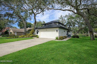 Set on an expansive golf course lot with mature, lush on Spruce Creek Golf Club in Florida - for sale on GolfHomes.com, golf home, golf lot