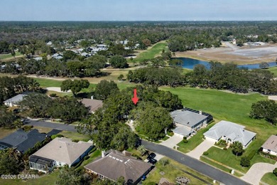 Set on an expansive golf course lot with mature, lush on Spruce Creek Golf Club in Florida - for sale on GolfHomes.com, golf home, golf lot