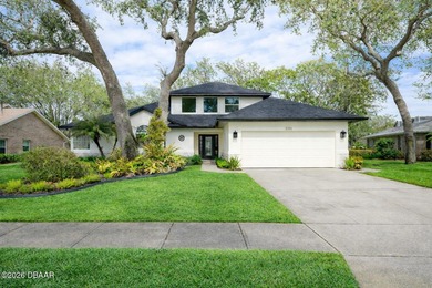 Set on an expansive golf course lot with mature, lush on Spruce Creek Golf Club in Florida - for sale on GolfHomes.com, golf home, golf lot