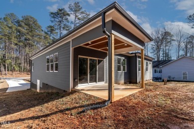 This modern custom-built home in Lake Royale is absolutely on River Golf and County Club at Lake Royale in North Carolina - for sale on GolfHomes.com, golf home, golf lot