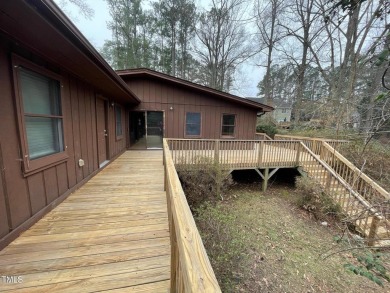 No need to go the mountains!! This  picturesque original log on Carolina Trace Country Club in North Carolina - for sale on GolfHomes.com, golf home, golf lot