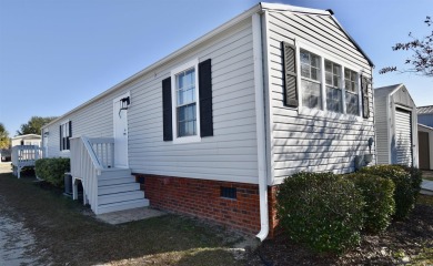 This charming 2-bedroom, 1-bathroom mobile home offers the on Barefoot Resort and Golf Club  in South Carolina - for sale on GolfHomes.com, golf home, golf lot