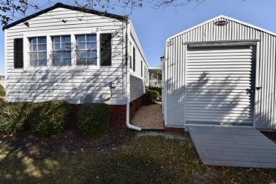 This charming 2-bedroom, 1-bathroom mobile home offers the on Barefoot Resort and Golf Club  in South Carolina - for sale on GolfHomes.com, golf home, golf lot
