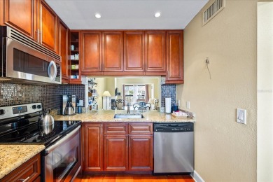 This second floor corner unit is in a gated community on Feather Sound Country Club in Florida - for sale on GolfHomes.com, golf home, golf lot