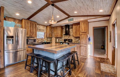 Sitting on three lots.  This Immaculate 3-bedroom, 2-bath home on Mountain Ranch Golf Club in Arkansas - for sale on GolfHomes.com, golf home, golf lot