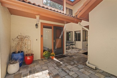 This exceptional end-unit townhome is strategically located on on The Grand Club - Pine Lakes Course in Florida - for sale on GolfHomes.com, golf home, golf lot