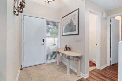 This exceptional end-unit townhome is strategically located on on The Grand Club - Pine Lakes Course in Florida - for sale on GolfHomes.com, golf home, golf lot