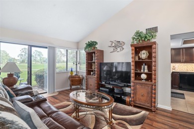 This exceptional end-unit townhome is strategically located on on The Grand Club - Pine Lakes Course in Florida - for sale on GolfHomes.com, golf home, golf lot