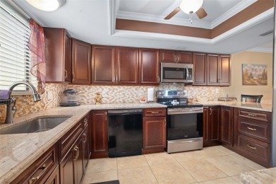 This exceptional end-unit townhome is strategically located on on The Grand Club - Pine Lakes Course in Florida - for sale on GolfHomes.com, golf home, golf lot