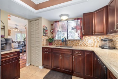 This exceptional end-unit townhome is strategically located on on The Grand Club - Pine Lakes Course in Florida - for sale on GolfHomes.com, golf home, golf lot