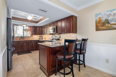 This exceptional end-unit townhome is strategically located on on The Grand Club - Pine Lakes Course in Florida - for sale on GolfHomes.com, golf home, golf lot