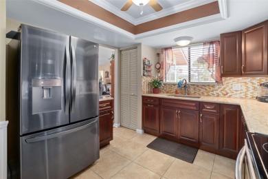 This exceptional end-unit townhome is strategically located on on The Grand Club - Pine Lakes Course in Florida - for sale on GolfHomes.com, golf home, golf lot