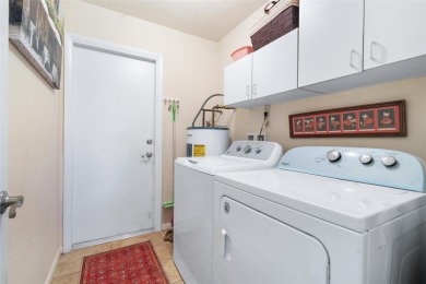 This exceptional end-unit townhome is strategically located on on The Grand Club - Pine Lakes Course in Florida - for sale on GolfHomes.com, golf home, golf lot