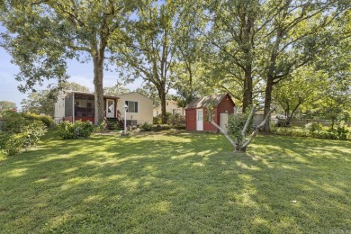 Nestled on a well-maintained corner lot, this charming bungalow on The Greens At North Hills Country Club in Arkansas - for sale on GolfHomes.com, golf home, golf lot