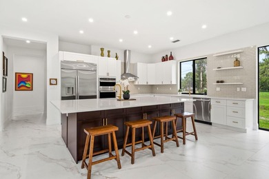 Step into your own private resort compound in Palm Beach Country on Jupiter Country Club in Florida - for sale on GolfHomes.com, golf home, golf lot