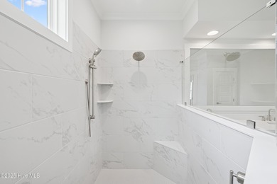 Discover the Skiff, a beautiful new Logan Home, located in on Sea Trail Golf Resort in North Carolina - for sale on GolfHomes.com, golf home, golf lot