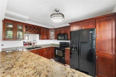 Enjoy easy living with stunning golf course views in the on Wynmoor Golf Course in Florida - for sale on GolfHomes.com, golf home, golf lot
