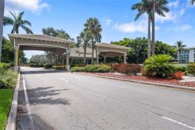 Enjoy easy living with stunning golf course views in the on Wynmoor Golf Course in Florida - for sale on GolfHomes.com, golf home, golf lot