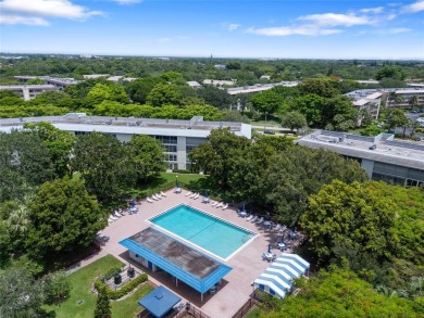 Enjoy easy living with stunning golf course views in the on Wynmoor Golf Course in Florida - for sale on GolfHomes.com, golf home, golf lot