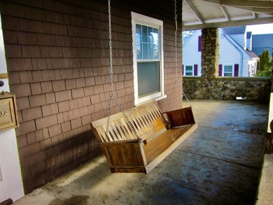 Inviting you~is the wrap around porch and porch swing as you on Derryfield Country Club in New Hampshire - for sale on GolfHomes.com, golf home, golf lot