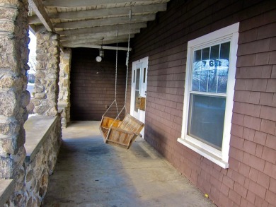 Inviting you~is the wrap around porch and porch swing as you on Derryfield Country Club in New Hampshire - for sale on GolfHomes.com, golf home, golf lot