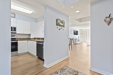 Step into the open-plan living space where light floods in on Barefoot Resort and Golf Club  in South Carolina - for sale on GolfHomes.com, golf home, golf lot