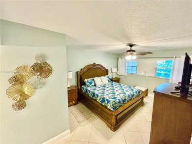 Welcome home to this warm and inviting, FULLY FURNISHED TURNKEY on Palm-Aire Country Club and Resort - Palms in Florida - for sale on GolfHomes.com, golf home, golf lot