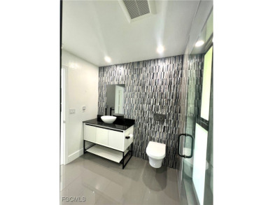 Modern Elegance Meets Florida Living in Imperial Golf Estates! on Imperial Golf Club in Florida - for sale on GolfHomes.com, golf home, golf lot